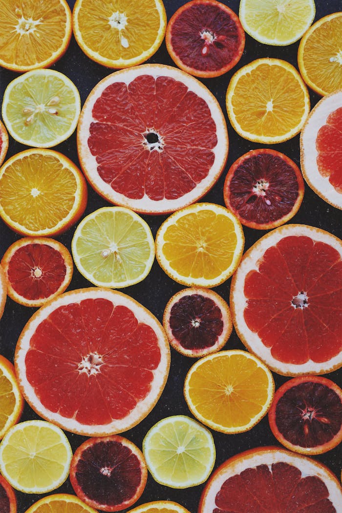 Bright and fresh assortment of colorful citrus fruit slices captured from above.